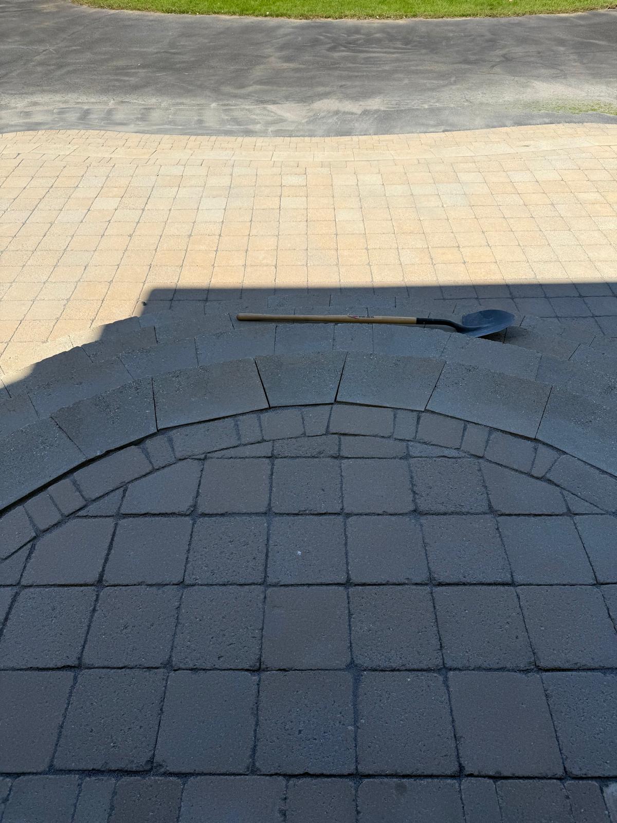 Curved dark paver step detail from above