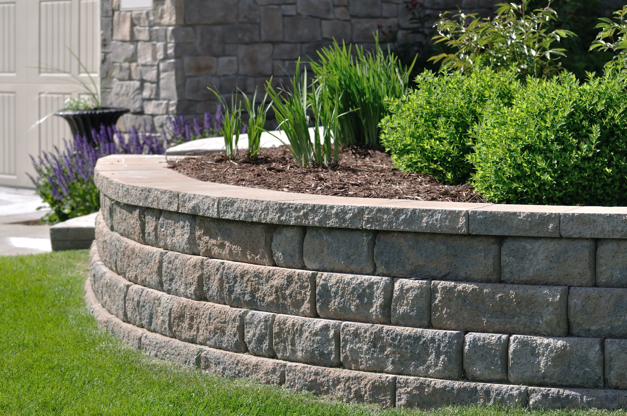 Backyard retaining wall integrated with interlock
