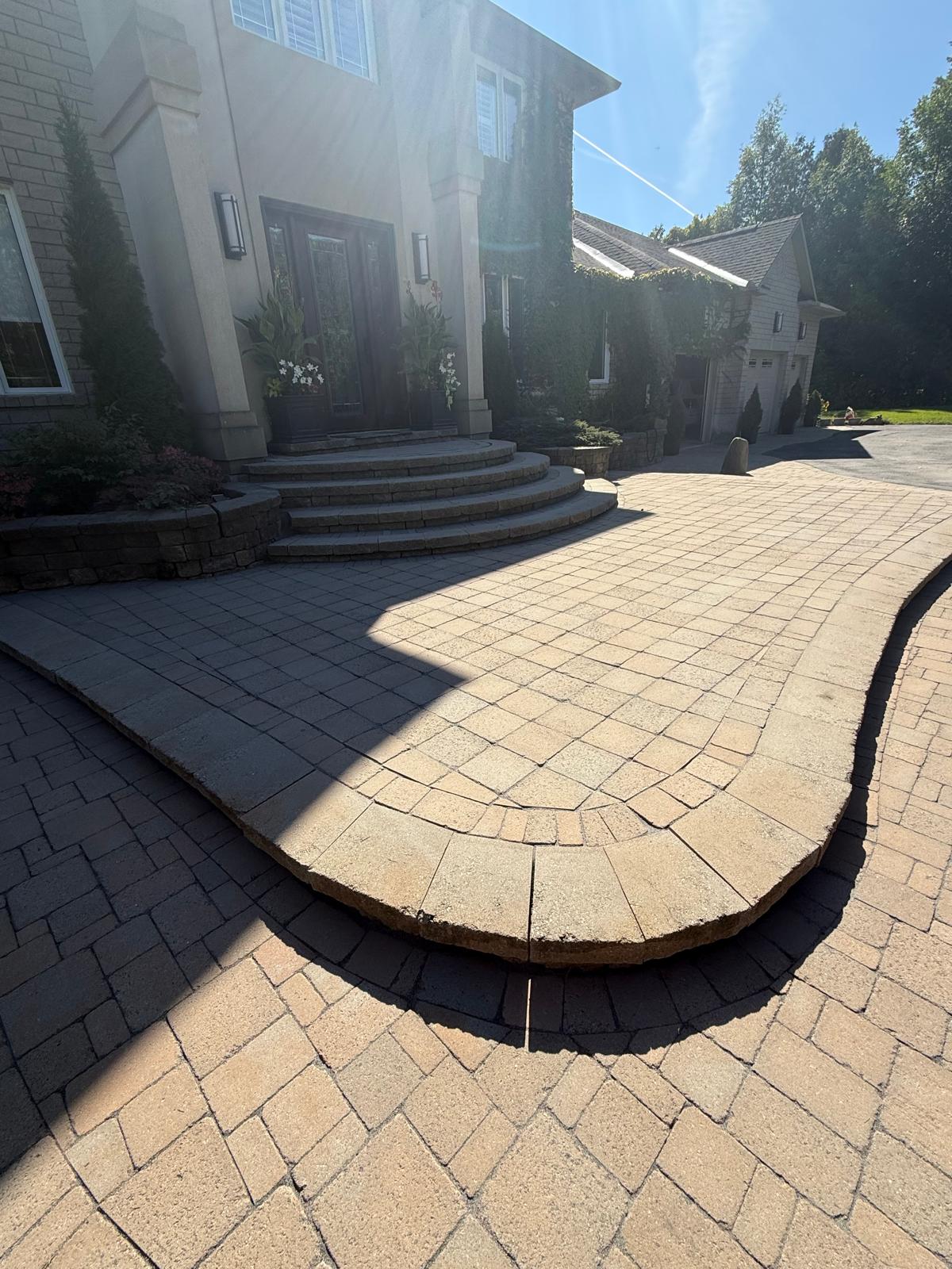 Staircase and driveway with two-tone paver design