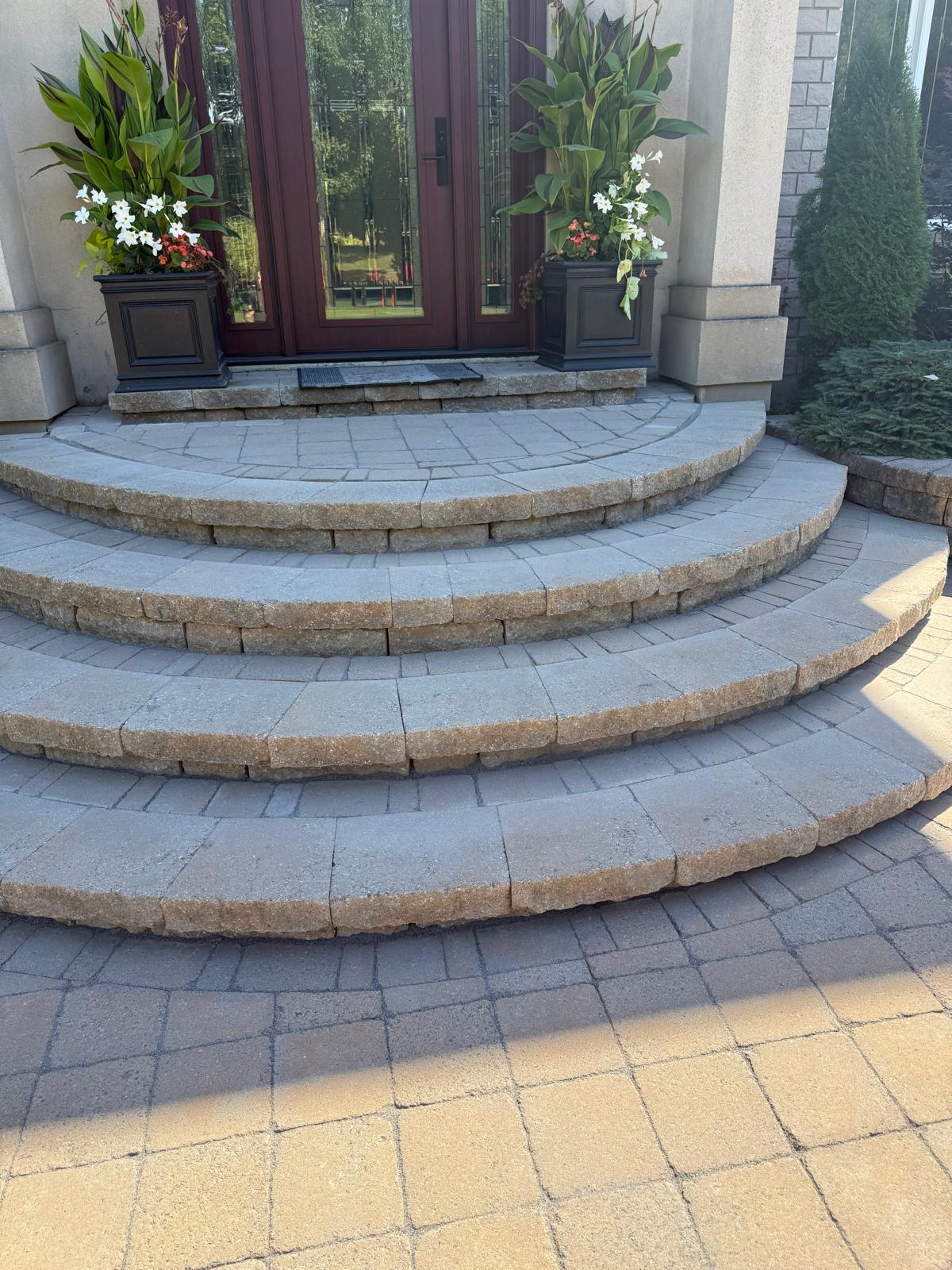 Curved four-step interlock staircase at a front entrance